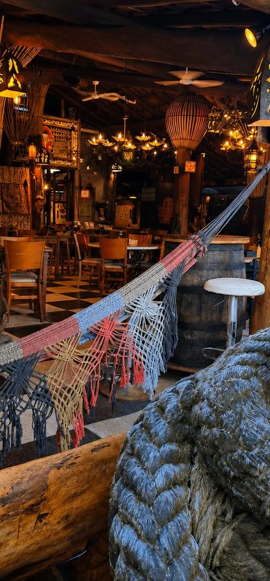 Salão aconchegante do restaurante Terral Maresias com iluminação suave e natureza
